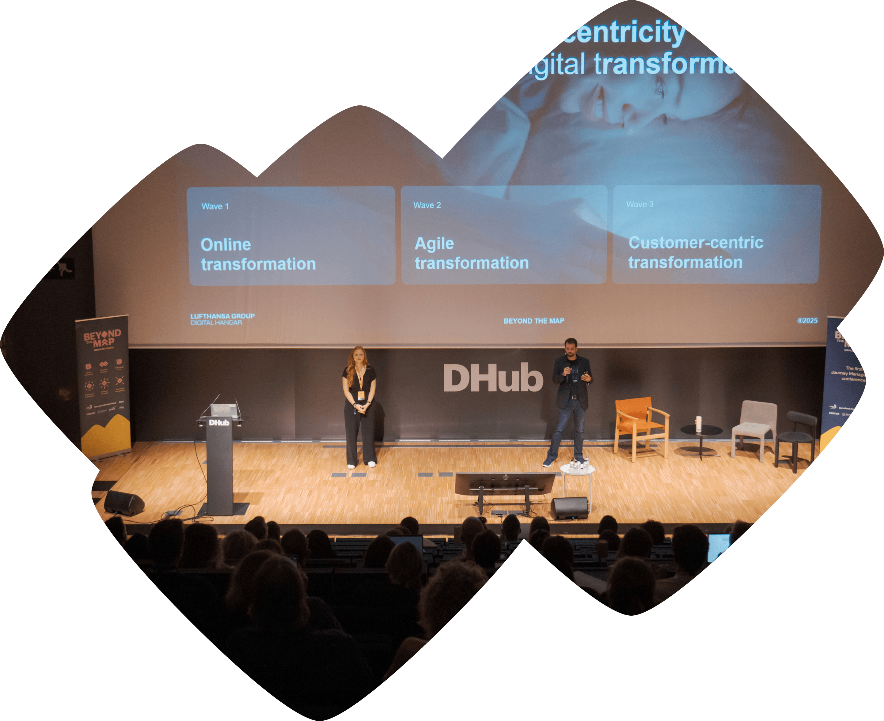 Speakers presenting on stage at Beyond the Map