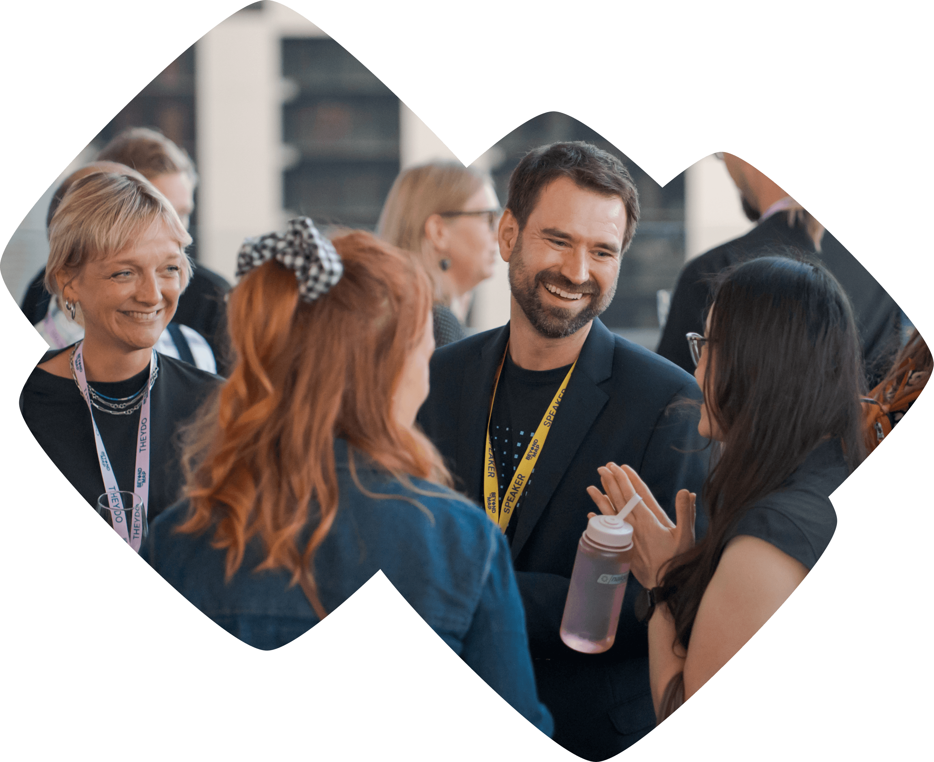 Event staff handing a lanyard and badge to an attendee at check-in